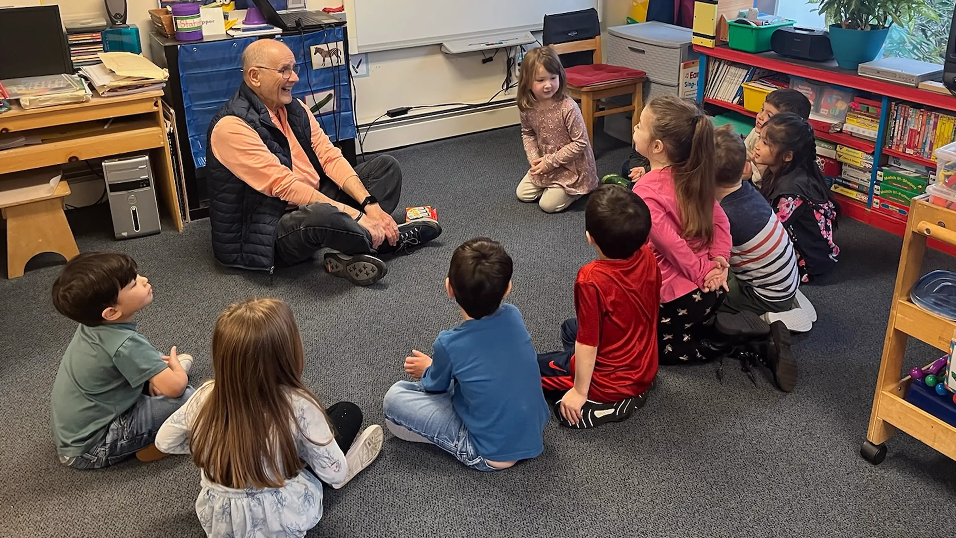 Man and children sitting on floor talking