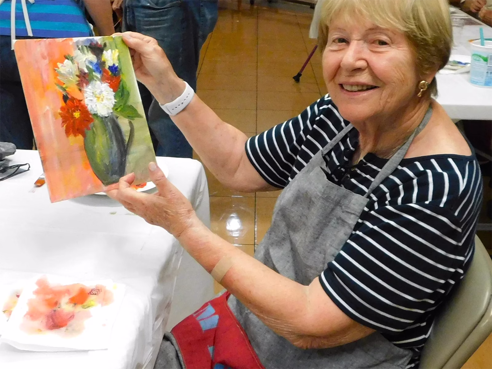 Resident displaying finished water color painting