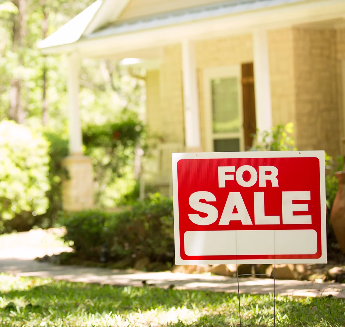 For sale sign in-front of home