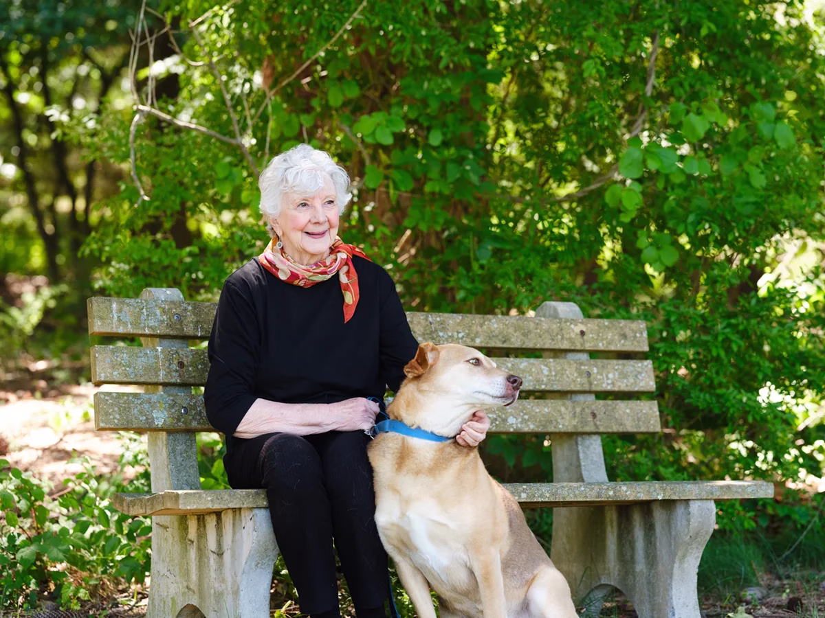 Woman sitting on bench with dog