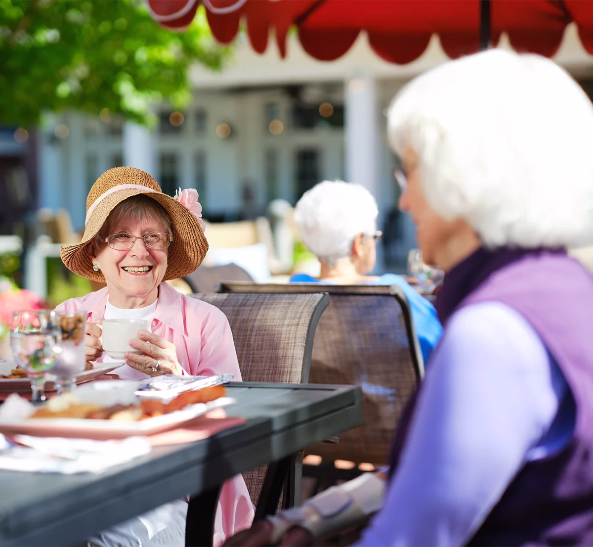 Women in conversation at outdoor table