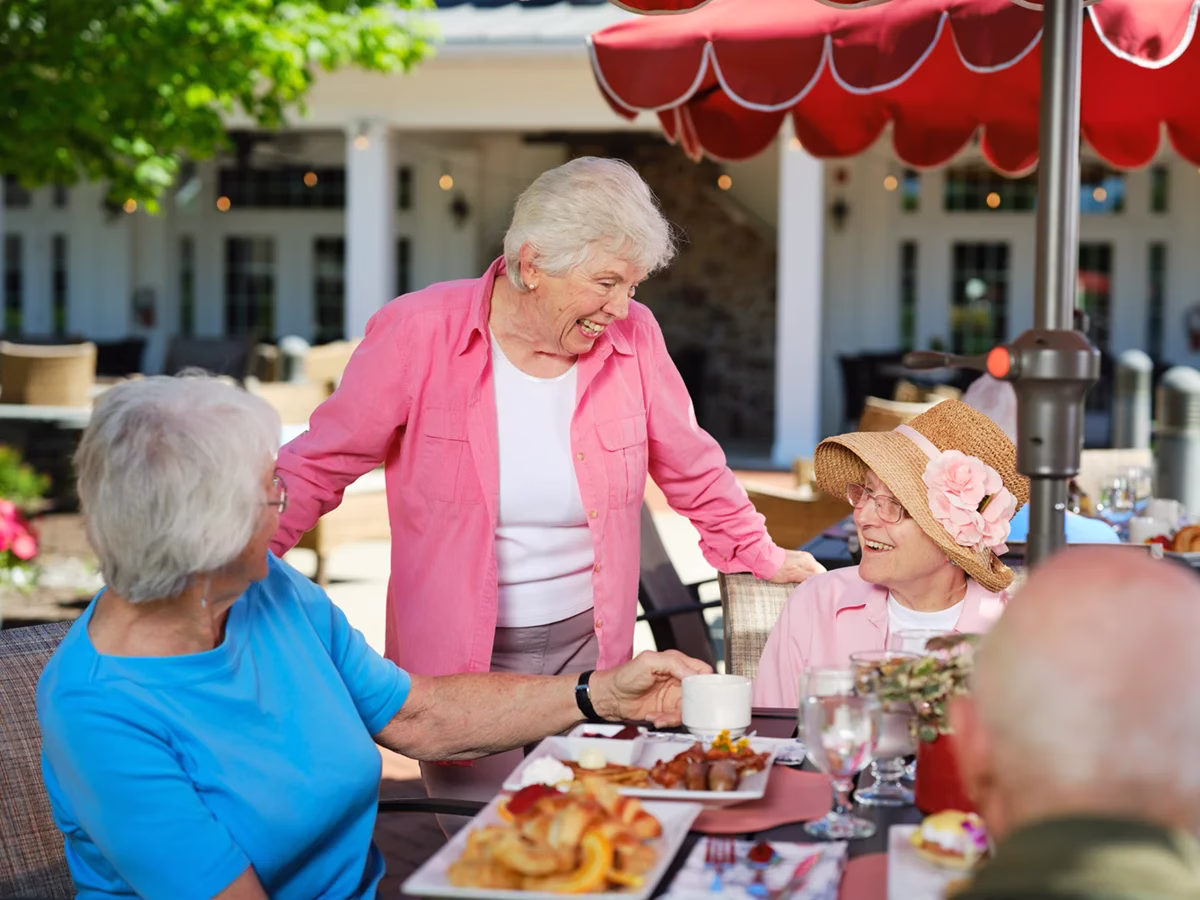 Residents talking at outside dinning area