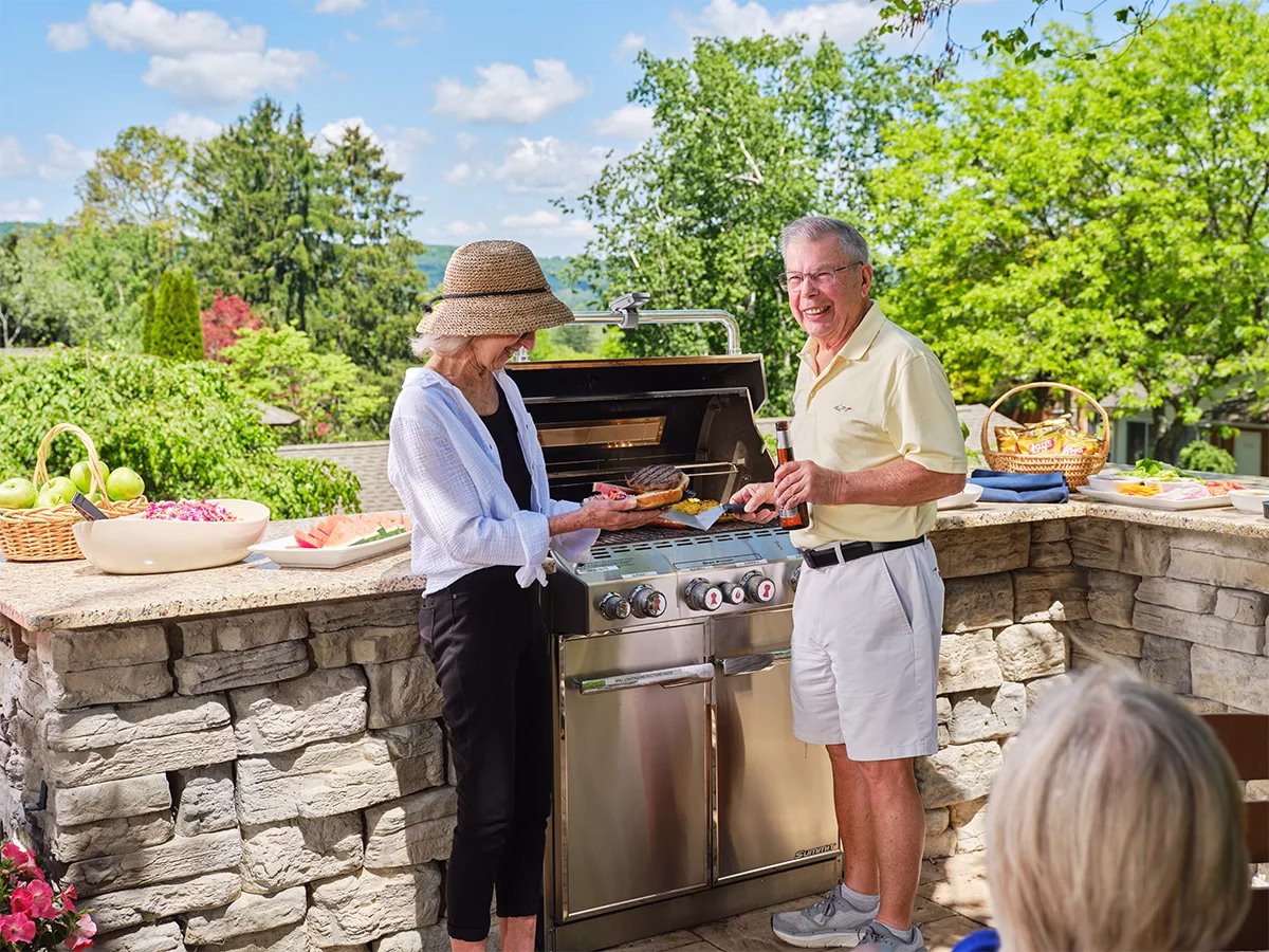 Man and woman grilling outside