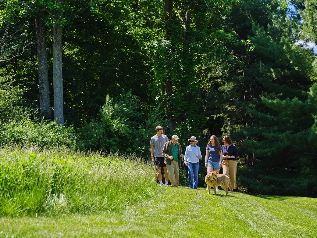 Residents and family walking path with dog