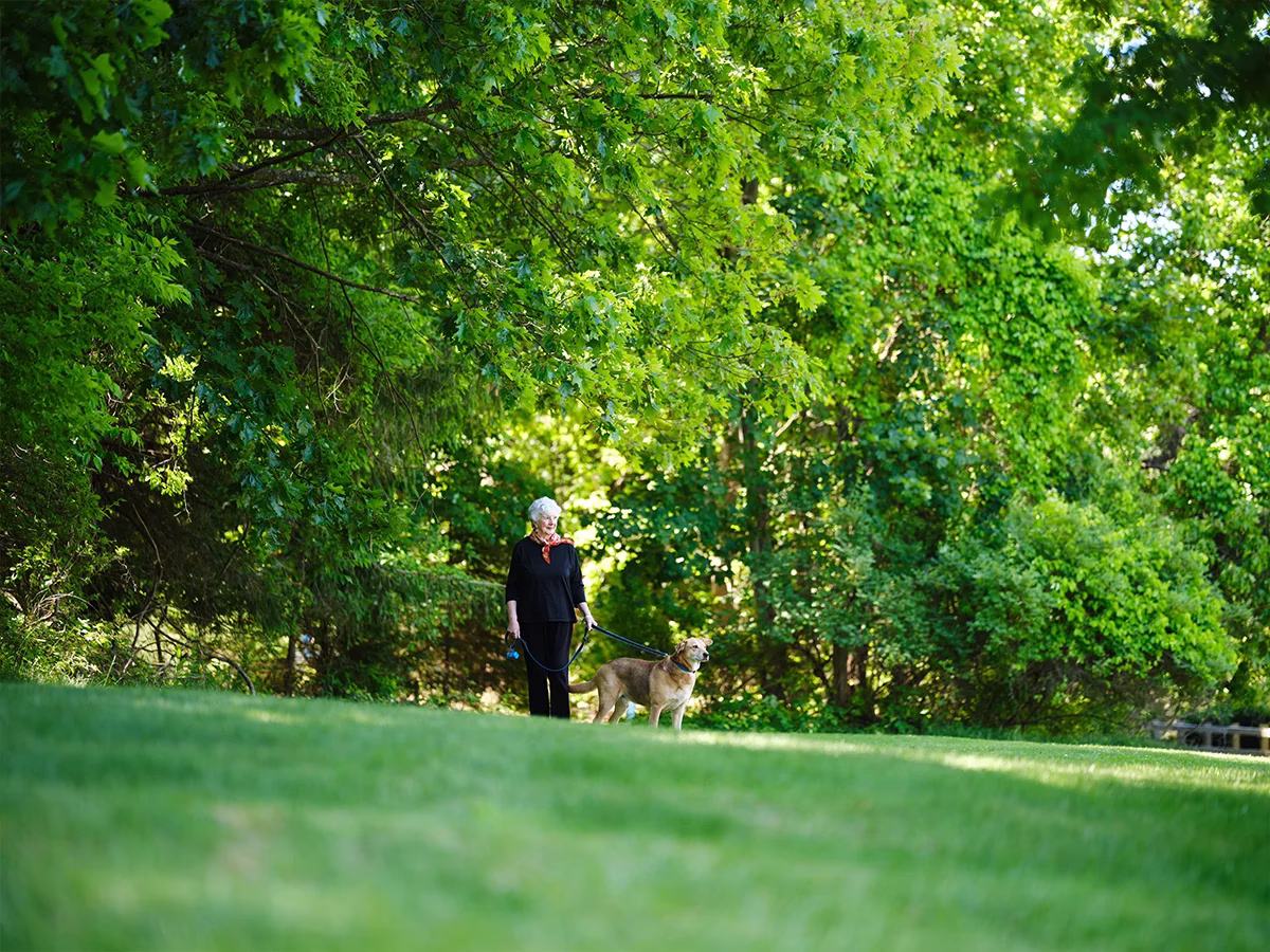 Woman walking dog outside