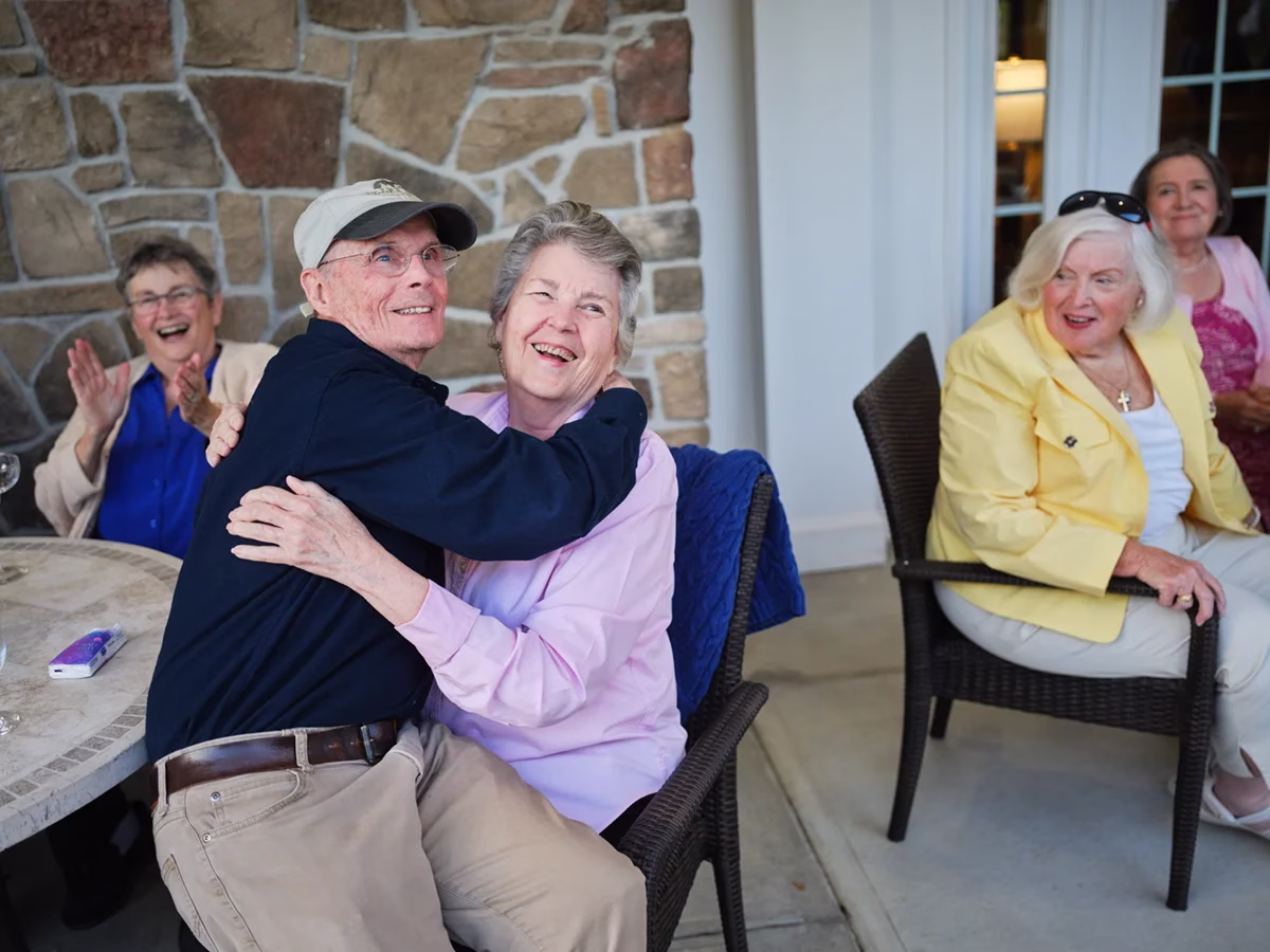 Residents laughing outside on patio