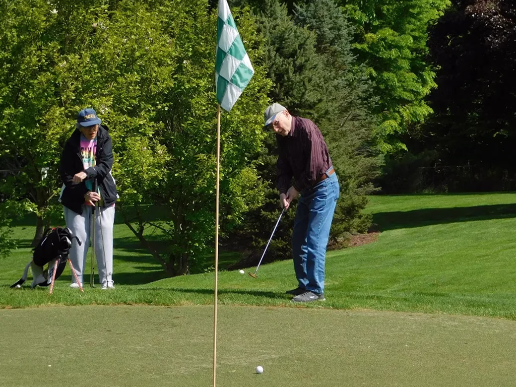 Resident putting golf ball
