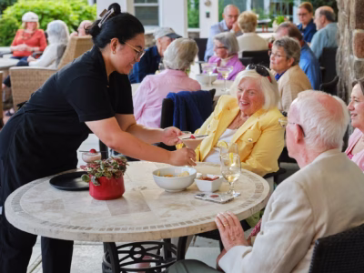 Server providing drinks to residents