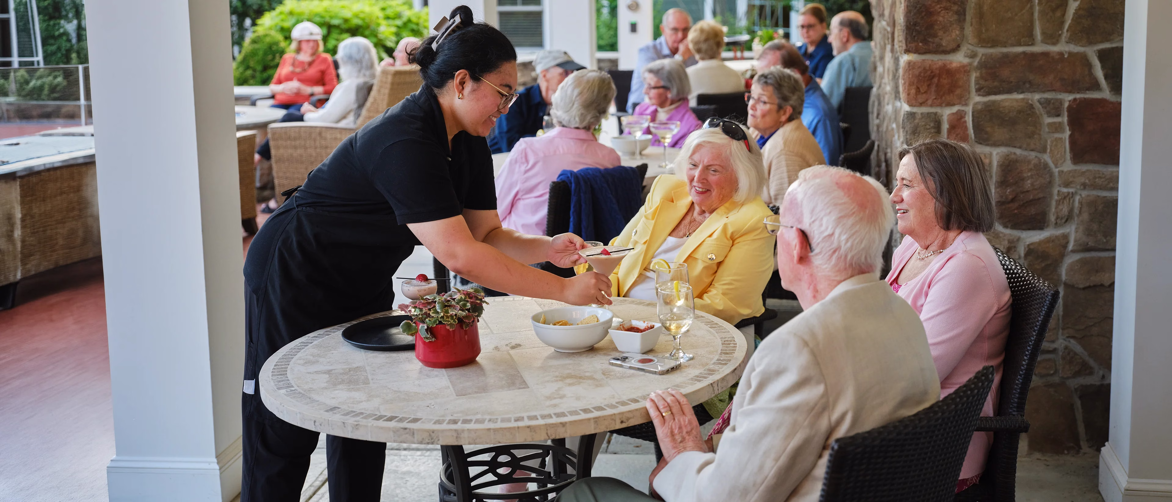 Server providing drinks to residents