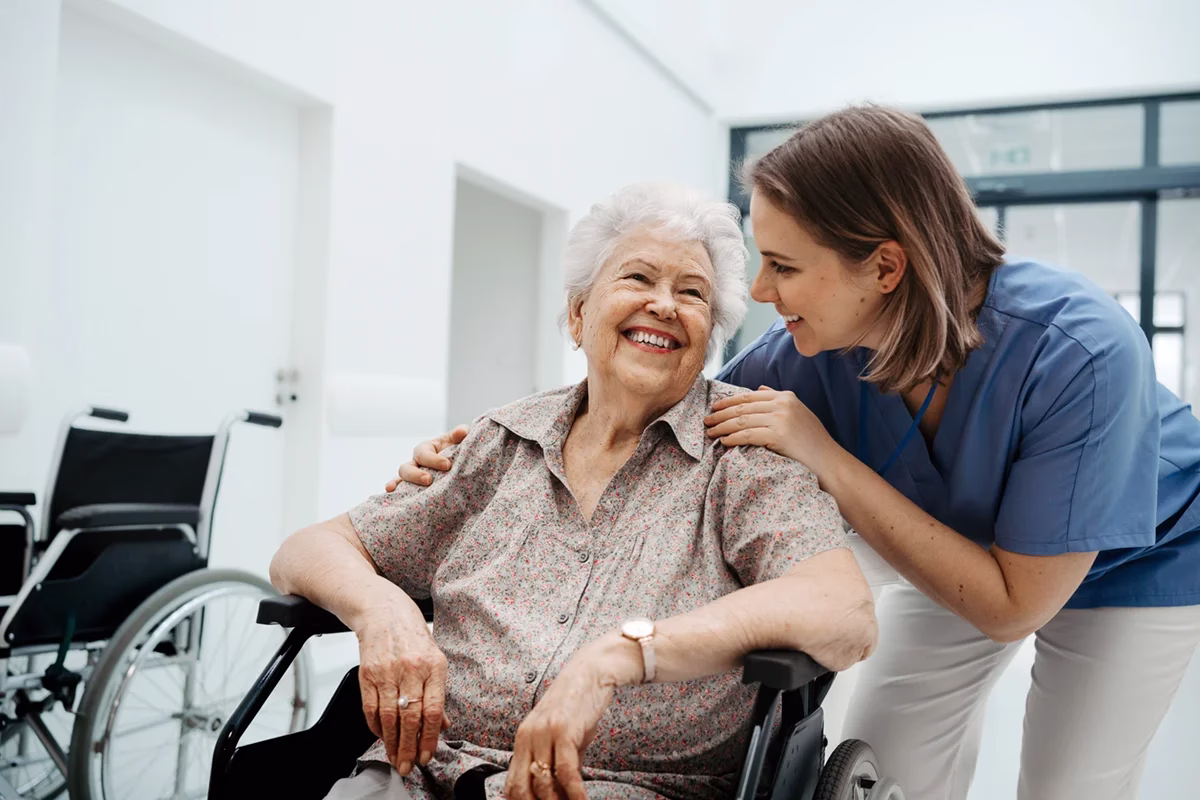 Woman in wheel chair and care giver