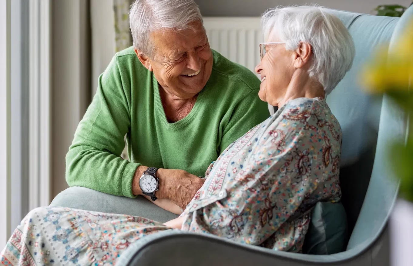 Man and woman in living room smiling