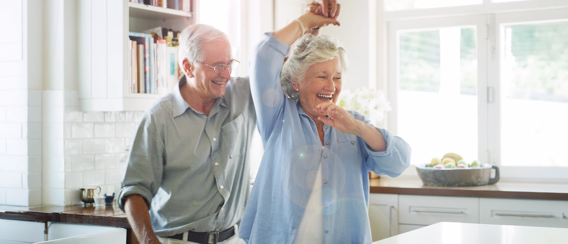 Man and woman happily dancing in kitchen