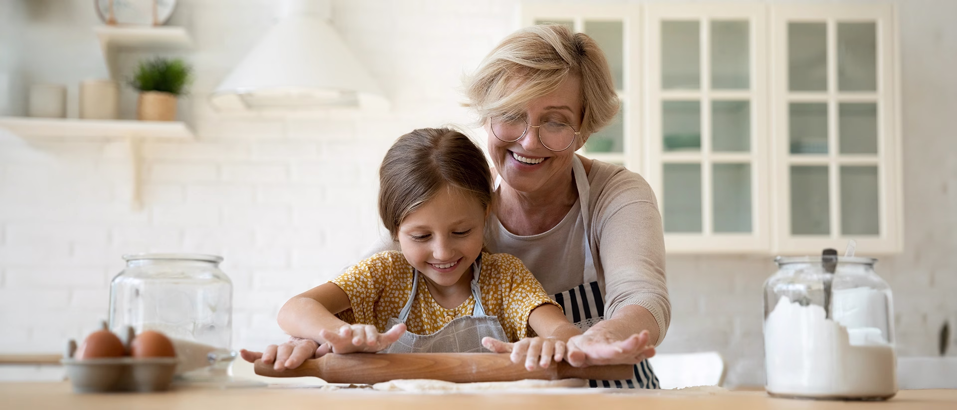 Woman teaching child how to make cookies