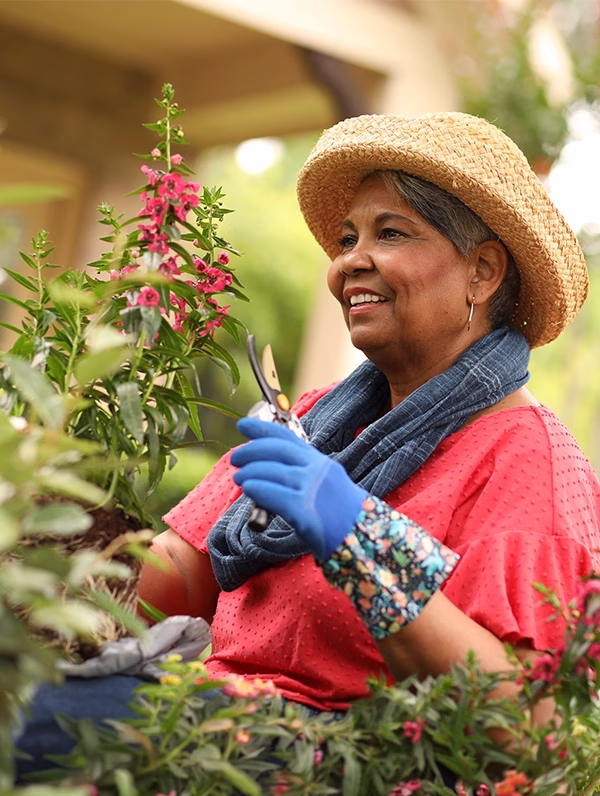 Woman tending to flowers in garden